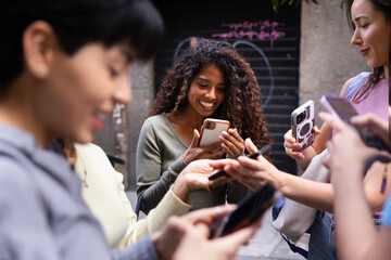 Group of friends enjoying social media on their smartphones