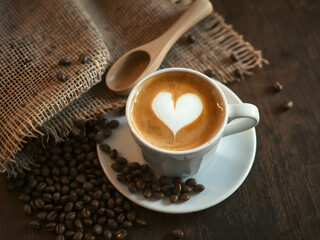 Heart Latte Art in Cup of Coffee with Beans on Rustic Wooden Table
