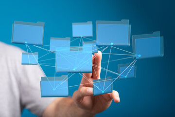 Hand interacting with a network of digital folders.  Cloud storage, data management.