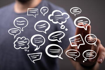 Image depicts a person interacting with virtual speech bubbles, symbolizing communication,...
