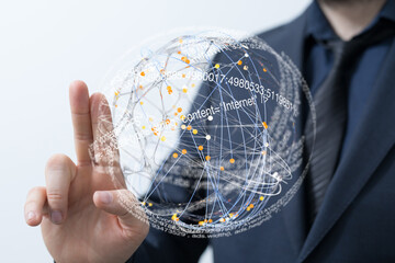 A businessman interacts with a digital globe, visualizing data and network connections.