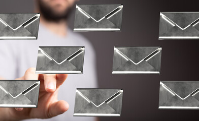 Abstract image of a man interacting with digital email icons, representing communication and...