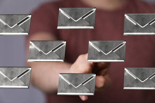 Person interacting with email icons, digital communication, inbox management, online correspondence.