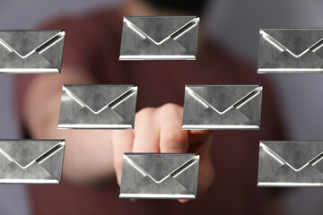 Close-up of a hand interacting with digital email icons.