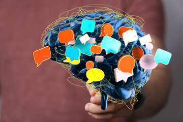 Conceptual image of a brain with colorful speech bubbles, representing communication, ideas, and...