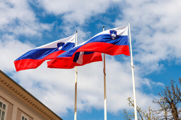 Three Slovenian flags waving in the wind in Ljubljana, Slovenia, Europe