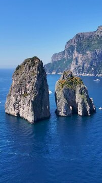 Faraglioni Island At Capri In Naples Italy. Beach Landscape. Giant Cliffs Scene. Faraglioni Island At Capri In Naples Italy. Gulf Of Naples Skyline. Mediterranean Sea Coast. Scenic Capri Island.