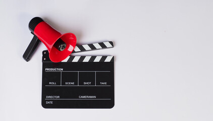 Clapper board and red megaphone on white background.