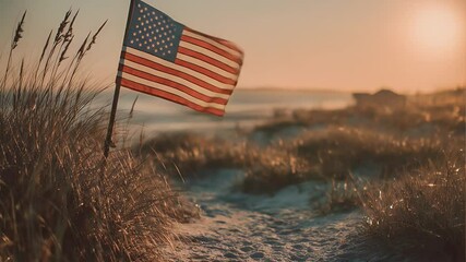 American flag waving at sunset on sandy beach - Powered by Adobe