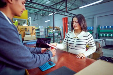 Customer paying with nfc technology on smartphone in retail store