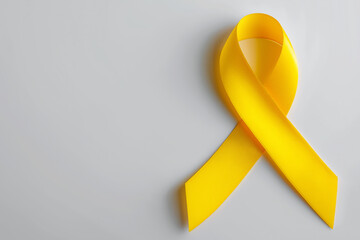 Yellow ribbon symbolizes hope and support, plain background, copy space. International Albinism Awareness Day