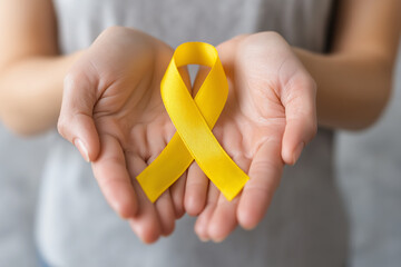 Intrtrnational Albinism Awareness Day. Hands holding yellow ribbon