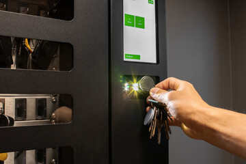 Person using RFID key fob for secure access control system with key management. Ideal for security,...