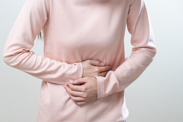 Flatulence asian young woman intolerance hand in stomach ache, suffer from food poisoning,...