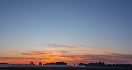 Colorful dawn in summer, orange sky early in the morning