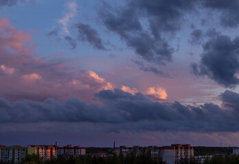 Stormy sky at sunset, bulky clouds on the horizon