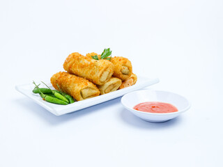 Indonesian crispy rissoles , served on a white plate with spicy red chili sauce and green chili on a white background. Perfect photo of a traditional snack.