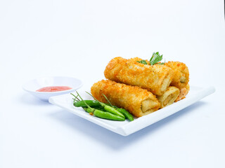 Indonesian crispy rissoles , served on a white plate with spicy red chili sauce and green chili on a white background. Perfect photo of a traditional snack.