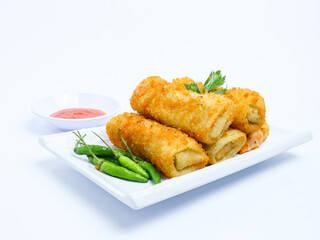 Indonesian crispy rissoles , served on a white plate with spicy red chili sauce and green chili on a white background. Perfect photo of a traditional snack.