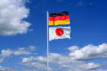 Partnership, relations between Germany and Japan symbolised by national flags