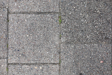 Texture of the grungy, gray walkway tiles in eastern europe