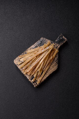 Food, snacks or jerky made from dried dehydrated salted fish with spices. Snacks fish