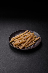 Food, snacks or jerky made from dried dehydrated salted fish with spices. Snacks fish