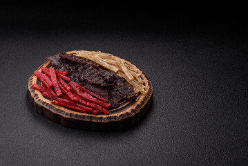 A set of jerky or snacks of beef, chicken and fish with salt and spices