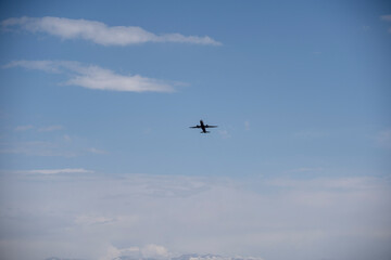 Passenger Plane Taking Off Against Blue Sky and Clouds