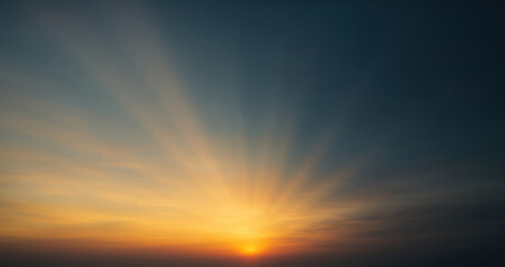 Golden hour sunburst at dawn or sunset in shades of yellow and dark deep green