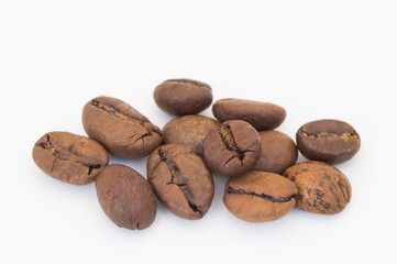 Macro photography of several roasted coffee beans on a white background
