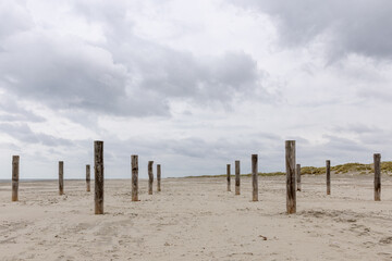 Wooden poles on the beach of the island of Schiermonnikoog