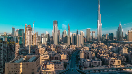 Fototapeta premium Dubai Downtown skyline timelapse with Burj Khalifa and other towers during sunrise panoramic view from the top in Dubai
