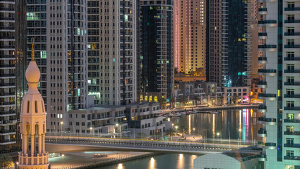 Dubai Marina skyscrapers and promenade aerial night to day timelapse, Dubai, United Arab Emirates