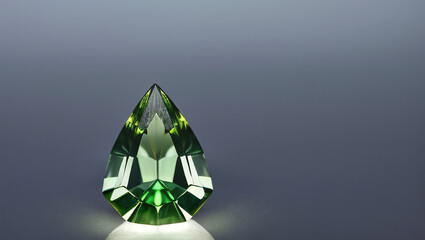 Green Faceted Gemstone on Gray Background – Luxury Emerald Look