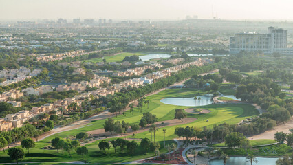 Aerial view to villas and houses with Golf course with green lawn and lakes timelapse