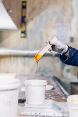 guy makes glue and glues wooden panels on the manufacture of skateboards