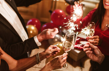 Elegant champagne toast celebration with sparklers. Luxury party scene featuring friends cheering...