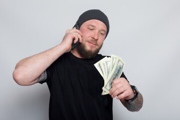 Young man throws money to camera.