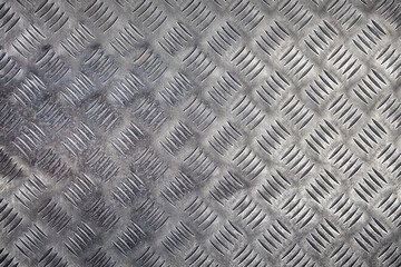 Detailed pattern of metallic flooring showcasing diamond plating in a contemporary industrial setting