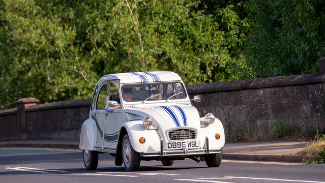 Milton Keynes,Bucks,UK - June 1st 2025:  1986 white Citroen 2CV classic car driving on a British road.