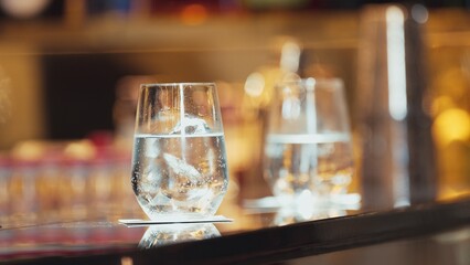 Closeup of gin fizz cocktail or tonic serving to customer background on luxury counter bar at nightclub in special beverage showcasing elegance nightlife mixology inviting in greeting guest. Vinosity.