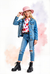 Young girl posing in a denim jacket and pink hat with heart shirt  