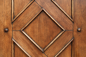 Elegant wooden surface features diamond-shaped decorative patterns, emphasizing craftsmanship and...
