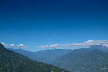 Obraz premium Moon over moonlit clouds in full moon night sky, sikkim, India