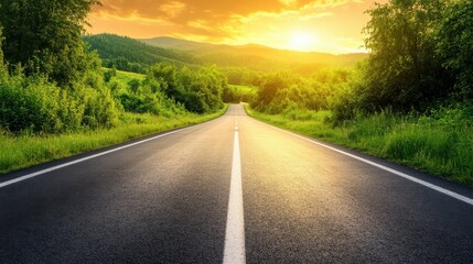 Fototapeta premium Scenic road trip through nature. Asphalt highway winds picturesque landscape surrounded by lush greenery and rolling hills. Warm tones of sunset cast golden glow over scene creating serene