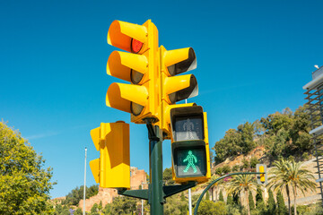 A green light is on at a pedestrian crossing. Safe crossing to the other side of the street