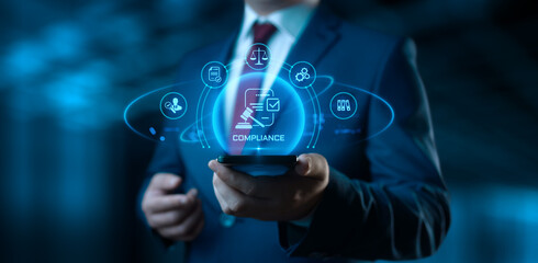 Businessman holding smartphone with compliance icons on screen - business and regulations concept