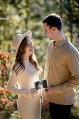 A Couple Joyfully Celebrating Their Pregnancy Announcement Surrounded by Beautiful Nature