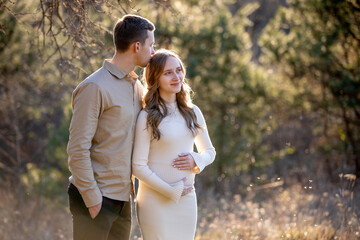 A Couple Joyfully Celebrating Their Pregnancy Announcement Surrounded by Beautiful Nature